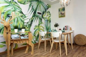Tangxi合肥市滨湖新区·云谷路地铁站·路客精品公寓·001297970的一间用餐室,配有桌椅和棕榈壁画