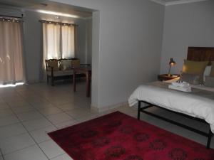 乌平通De Nachtuilen Guesthouse的一间卧室配有一张床和红色地毯