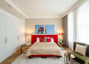 维也纳Roosevelt Stadthaus的一间卧室设有一张大床和红色床头板