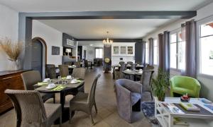 诺亚芒提亚Logis Hôtel La Chaize的用餐室设有桌椅和窗户。