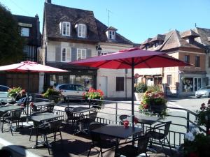 莱桑德利Chambre Saint-Sauveur的街上的一组桌椅和遮阳伞