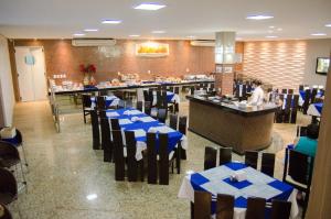 莫索罗维多利亚皇宫酒店的一间设有蓝色桌椅的餐厅和一间酒吧