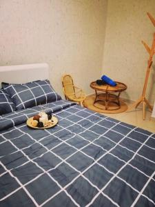 峇六拜槟城甜蜜公寓的一间卧室配有一张床,上面放着一个食物托盘
