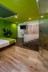 墨西哥城自然别墅旅馆的客房设有床、浴缸和绿色墙壁。