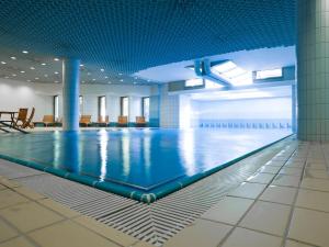 楚格Park Hotel Zug的蓝色天花板建筑中的游泳池