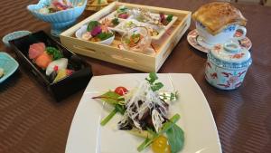 镜野OkutsuHotSpa IkedayaKajikaen的餐桌上放着食物和碗