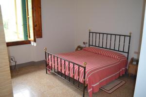 Vaglia帕德里诺酒店的一间卧室配有一张带红白毯子的床