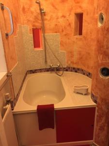 柏林Appartement am Tegeler See的带浴缸的浴室和红色毛巾