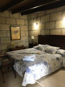 圣米格尔德阿沃纳Finca el Cortijo的一间卧室设有一张大床和砖墙