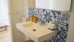 塞尔瓦卡萨哥马度假屋的浴室设有水槽和蓝色及白色瓷砖