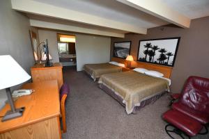 科斯塔梅萨Costa Mesa Inn - Newport Beach Area的酒店客房配有两张床和一张书桌