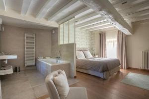 ChevannesLa Barbotiere的一间卧室配有一张床、一个浴缸和一个水槽