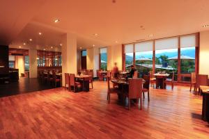 廷布Norkhil Boutique Hotel & Spa的餐厅设有桌椅和大窗户。