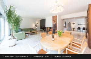 拜罗伊特HEJ Apartments Bayreuth的用餐室以及带桌椅的起居室。