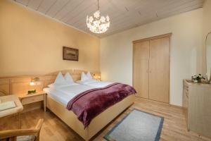 巴德加斯坦奥攀布莱克酒店的一间卧室配有一张大床和一个吊灯。