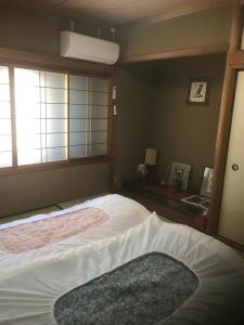 京都京都御宿敬旅馆的一间卧室设有一张大床和一个窗户。