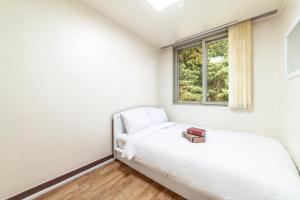 束草市HK Resort的一间卧室设有一张床和一个窗口