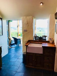 普尔赫利The Piggery - North Wales Retreat的一个带水槽和大窗户的厨房