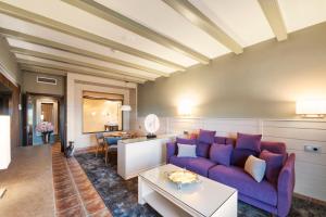 托雷努埃瓦Hotel La Caminera Club de Campo的客厅配有紫色沙发和桌子