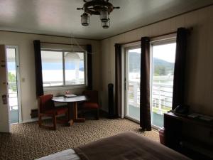 海恩斯Captain's Choice Motel的客房设有床、桌子和窗户。