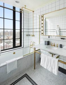 纽约勒德洛酒店的带浴缸、水槽和镜子的浴室