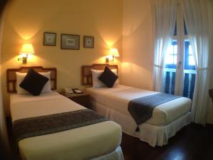 Perak Hotel客房内的一张或多张床位