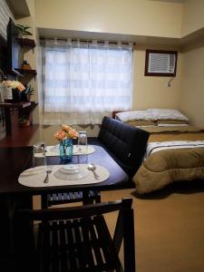 达沃市Joaquim Vacation Homes的客厅配有桌子和床。