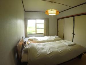 岩见泽市NORD house的客房设有两张床和窗户。