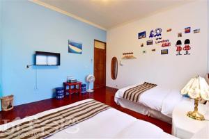 马公山水海岸民宿的一间带两张床的卧室和一台电视