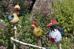 EbersteinFamilienbauernhof Gunzer-Sank的花园里的木棍上坐着三只公鸡
