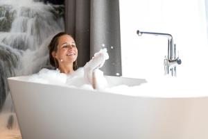 湖城帕斯农波斯特酒店的女人坐在带泡沫的浴缸里