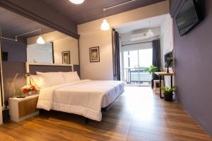 曼谷Mango 10 House的一间卧室设有一张大床和一个大窗户