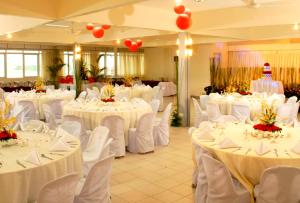 宿务夸特罗码头酒店的宴会厅配有白色的桌子和白色的椅子