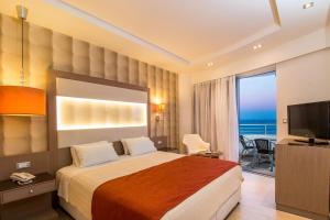 法里拉基Pegasos Deluxe Beach Hotel的酒店客房,设有一张床铺,享有海景