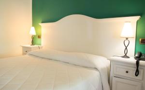 利帕里Hotel Villa Enrica - Aeolian Charme的卧室配有白色大床和绿色墙壁
