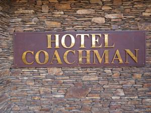 北帕默斯顿Distinction Coachman Hotel, Palmerston North的砖墙边的酒店竞技场标志