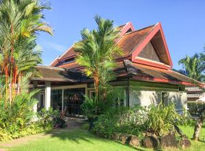 蔻立Sabai Private Pool Villa Khao Lak的前面有棕榈树的房子