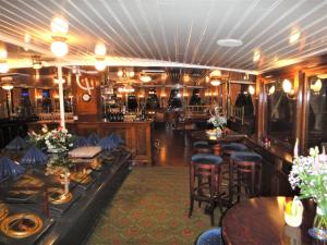 阿姆斯特丹卡皮腾安娜旅馆的一间带桌椅的餐厅和一间酒吧