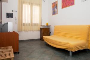 圣特雷莎加卢拉Bilocale Via Cairoli的一间卧室设有黄色的床和窗户。