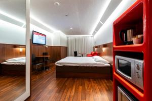 于韦斯屈莱韦斯屈莱欧美娜酒店的一间卧室配有一张床和一台电视。