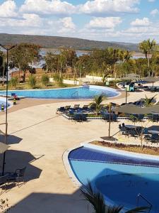 萨利诺波利斯SALINAS PARK RESORT的度假村内2个带桌椅的游泳池