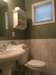 WesthamptonWesthampton Seabreeze Motel的一间带水槽、卫生间和镜子的浴室