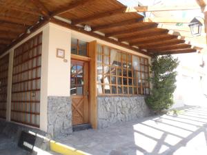 圣卡洛斯-德巴里洛切科特布斯酒店的一座带木门和石墙的房子