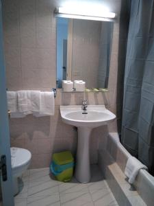 维戈黄金锚旅馆的一间带水槽、卫生间和镜子的浴室
