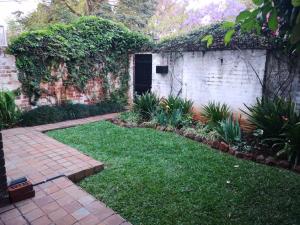 哈拉雷MYSECONDHOME的一座带砖墙和砖砌走道的花园