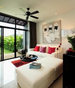 奈汉海滩Two Villas HOLIDAY - Onyx Style Nai Harn Beach, Phuket的客厅配有白色沙发和红色枕头。