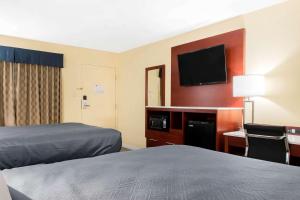 赫尔希Escape Inn Hershey的酒店客房设有两张床和一台平面电视。