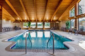 HesstonRodeway Inn的一个带木制天花板的室内游泳池和一个大型游泳池