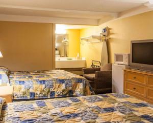 圣查尔斯Relax Inn Saint Charles的酒店客房设有两张床和一台平面电视。