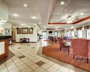 克林顿Quality Inn & Suites的大堂设有带桌椅的等候区